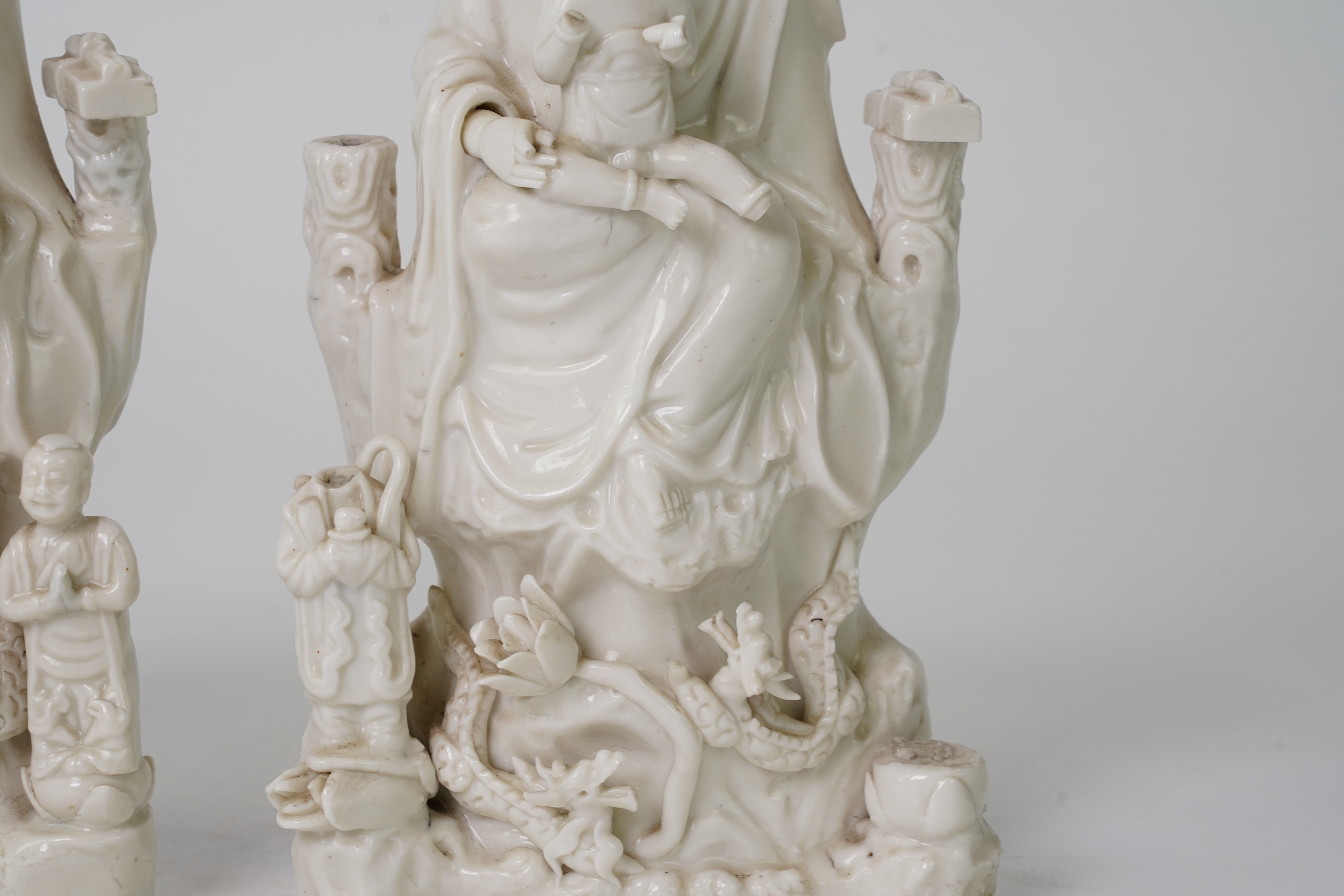 A pair of Chinese blanc de chine groups of Guanyin and children, 18th century